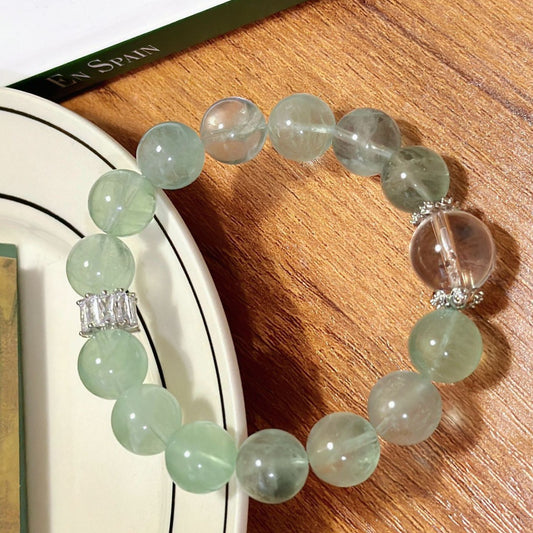 A close-up shot of green fluorite, with its fresh green color and ice-clear texture highlighting its stress-relieving energy properties