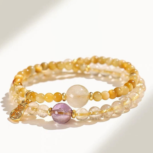 A panoramic view of the four-color energy bracelet featuring golden hairstone, yellow crystal, golden tiger's eye and amethyst, showcasing a powerful energy matrix