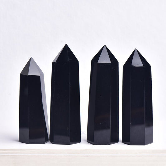 Front view of natural obsidian crystal point showing deep black luster