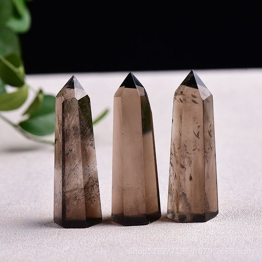 Main product shot of natural smoky quartz point showing smoky hue and hexagonal cut