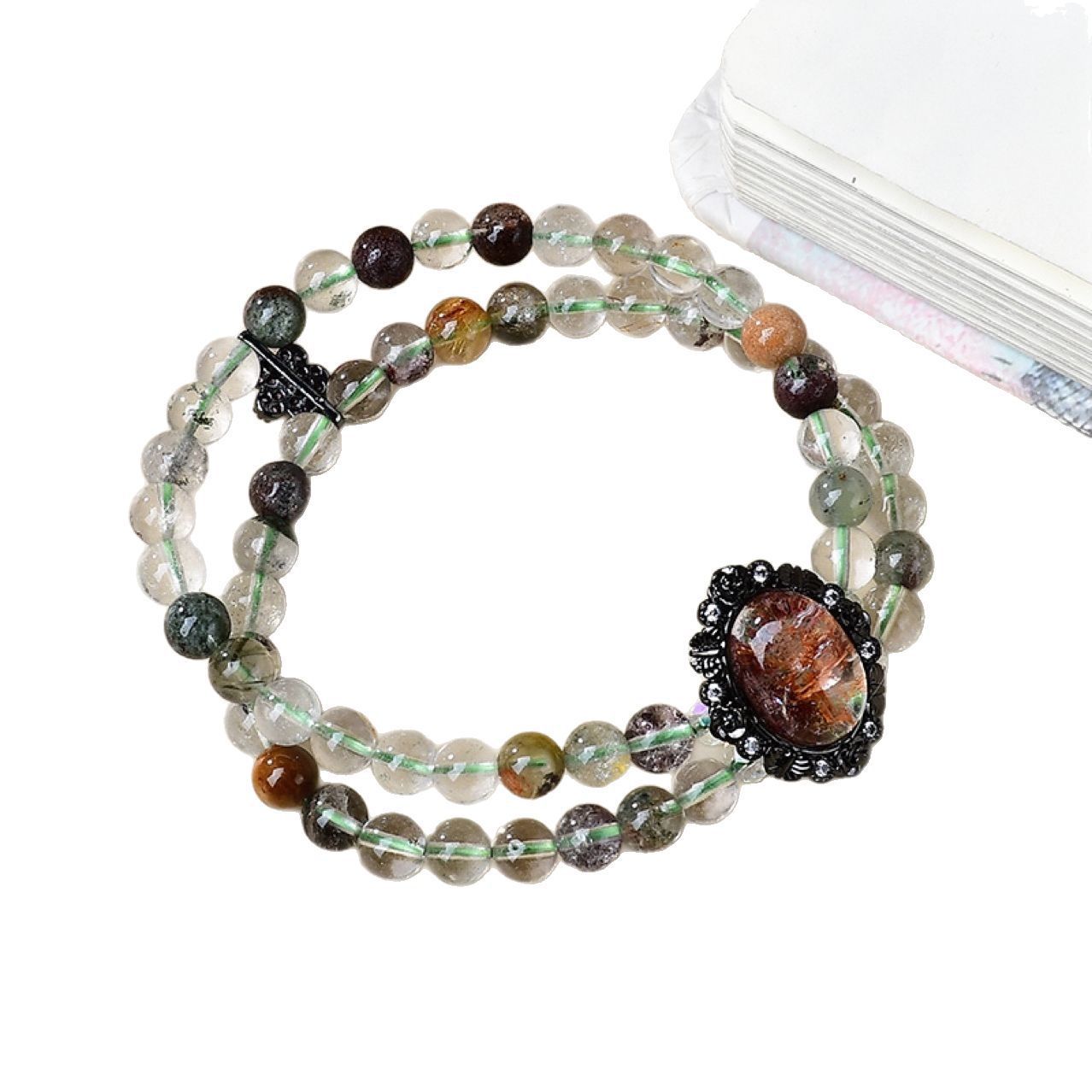 Highlight the green ghost beads containing the pyramid phantom, emphasizing their special energy attributes