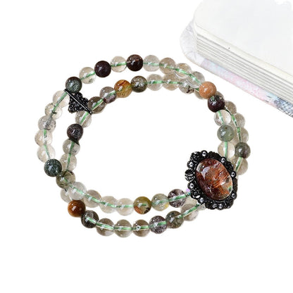 Highlight the green ghost beads containing the pyramid phantom, emphasizing their special energy attributes