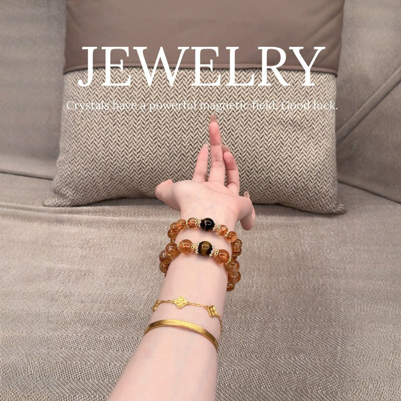 The multi-treasure bracelet is displayed flat, a perfect combination of yellow crystal for attracting wealth and strawberry crystal for attracting love