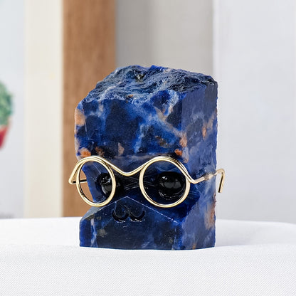 A hedgehog figurine placed together with a student ID card and a graduation thesis symbolizes academic success.