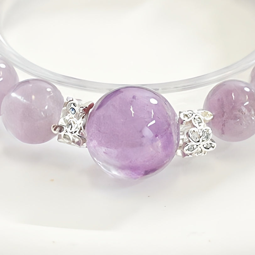 The bracelet is worn on the wrist and paired with minimalist clothing, highlighting understated luxury and a unique texture