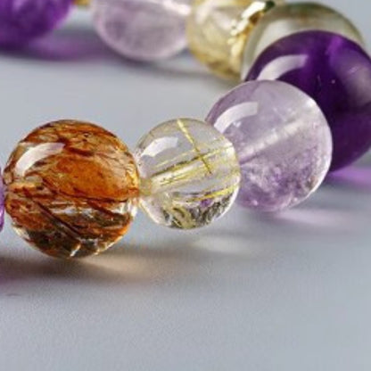 A close-up of the bracelet laid flat highlights its dual effects of all-round energy protection and powerful wealth attraction