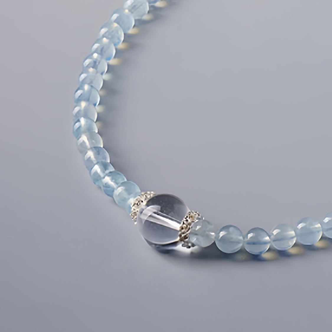 A close-up of aquamarine's clear blue color highlights its effects on communication and emotional balance