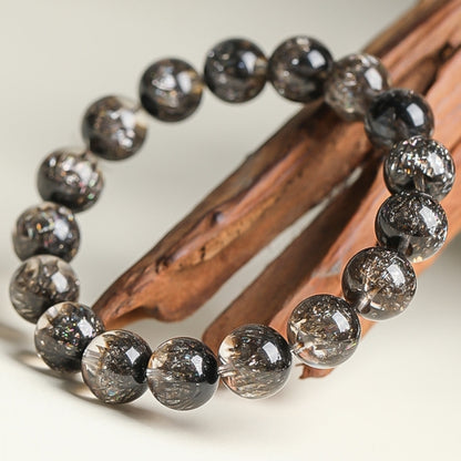 Close-up of the deep blackcurrant color treasure basin Black Super Seven bracelet, revealing the internal seven-color mineral inclusions and the shape of the treasure basin