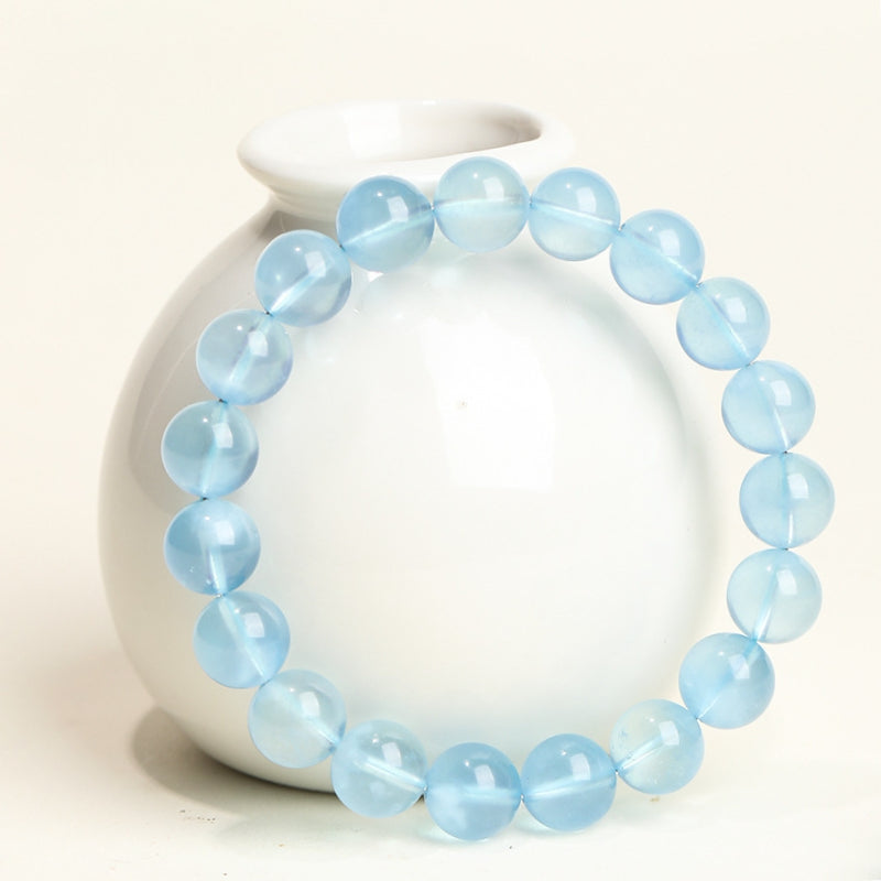 The Santa Maria Blue Aquamarine bracelet is displayed in natural light, highlighting its deep blue color and ultimate transparency