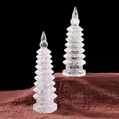 Holding a white crystal tower, it showcases its exquisite carving craftsmanship and natural pure texture.