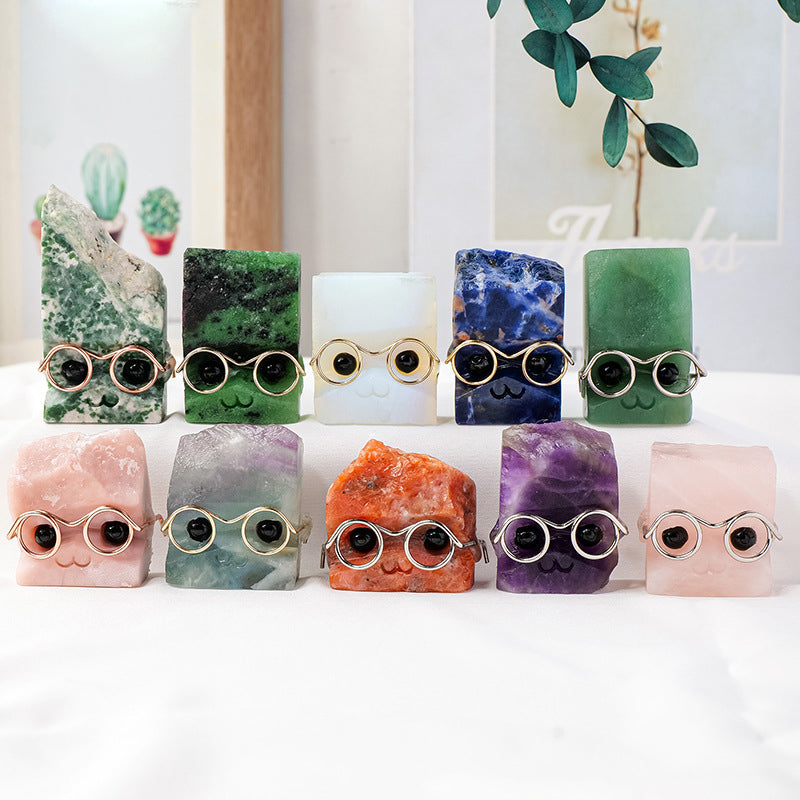 The close-up shot showcases the hedgehog's exquisite gold-rimmed glasses and the transparent texture of the natural crystal.