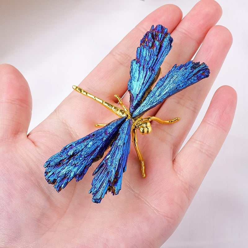 The sculpture serves as the focal point of the creative workbench, surrounded by design sketches and paints scattered around