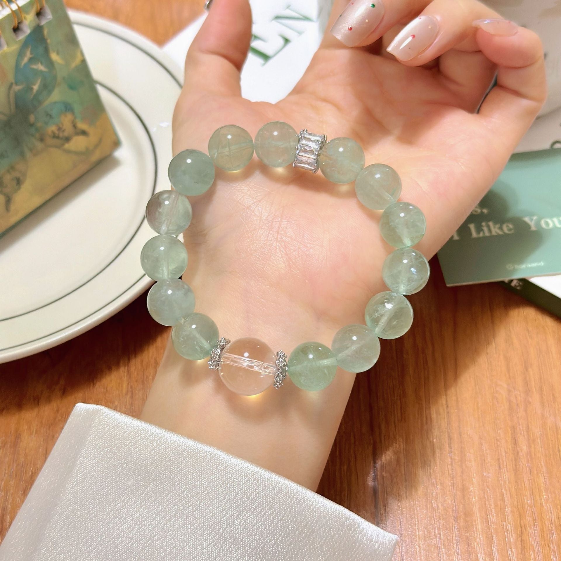 The bracelet is paired with creative tools. Green fluorite inspires creativity and white crystal enhances concentration