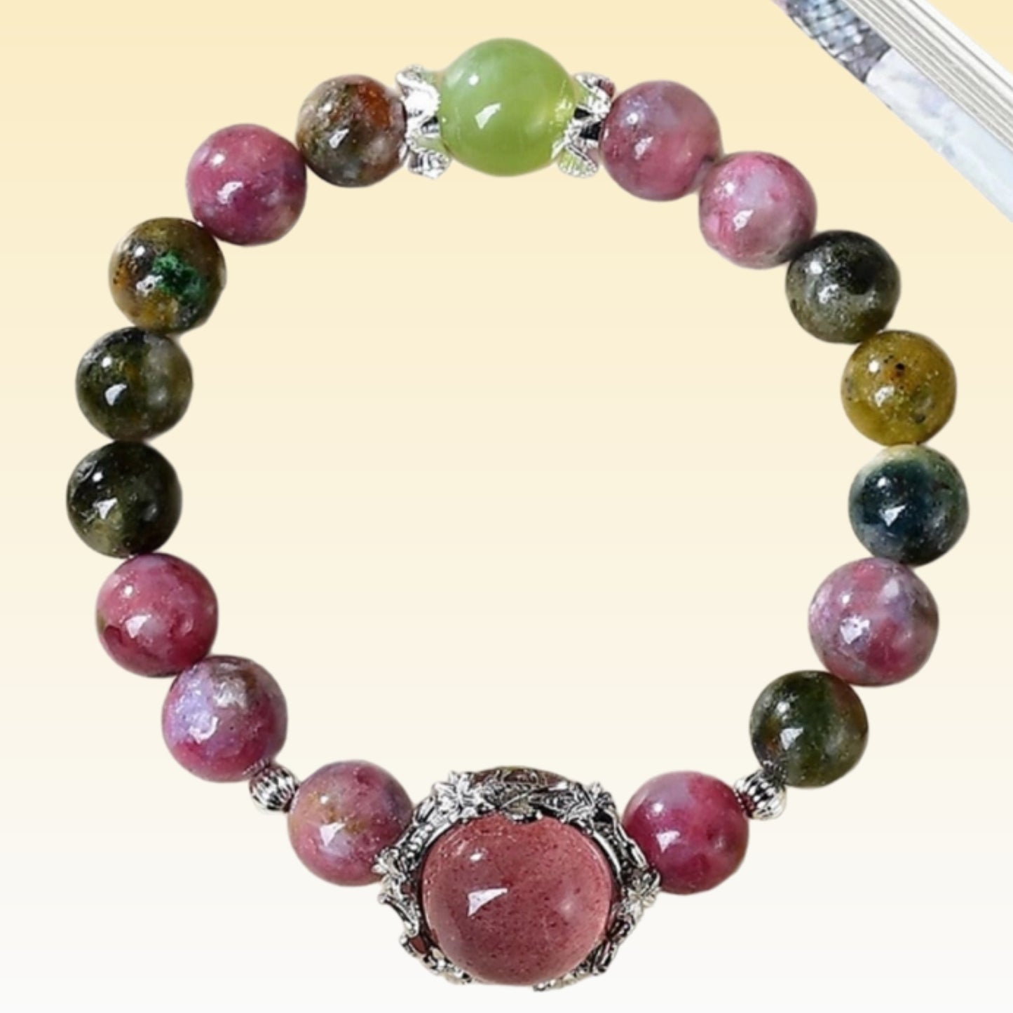 The tourmaline strawberry crystal bracelet, when paired with creative tools, symbolizes the energy that inspires creativity and promotes the flow of inspiration
