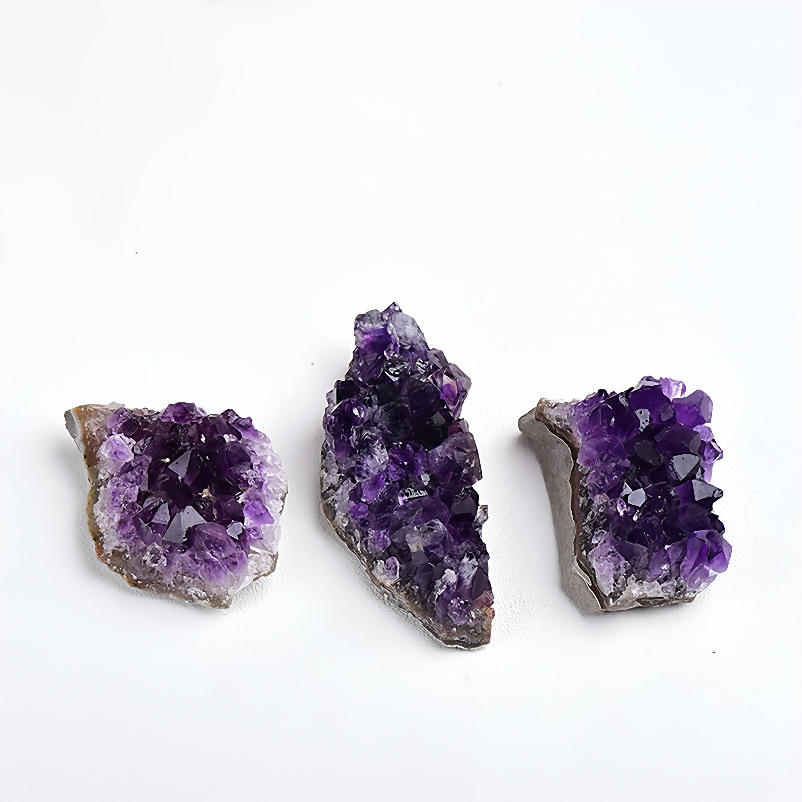 Amethyst clusters are placed beside the computer monitor on the desk, serving as energy guardians to neutralize electromagnetic radiation and enhance concentration and creativity.