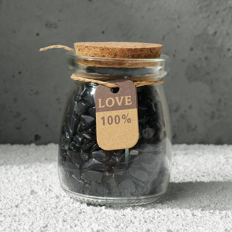 A pair of eyes were intently fixed on the crystal bottle, visualizing the intention setting.