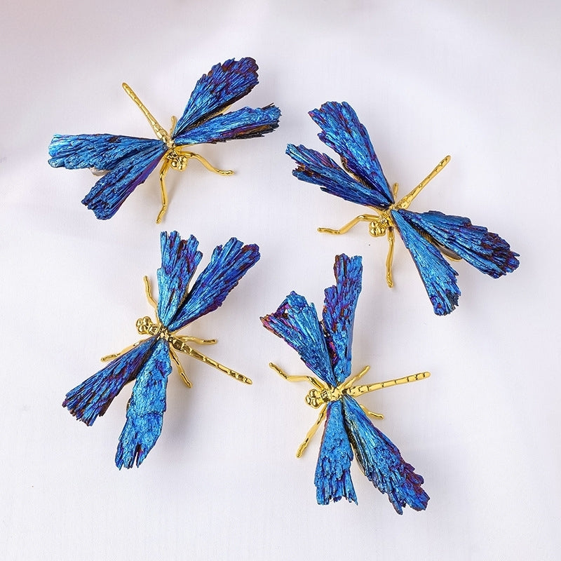 The energy dragonfly butterfly sculpture spreads its black tourmaline wings on the desk, with an open laptop placed beside it