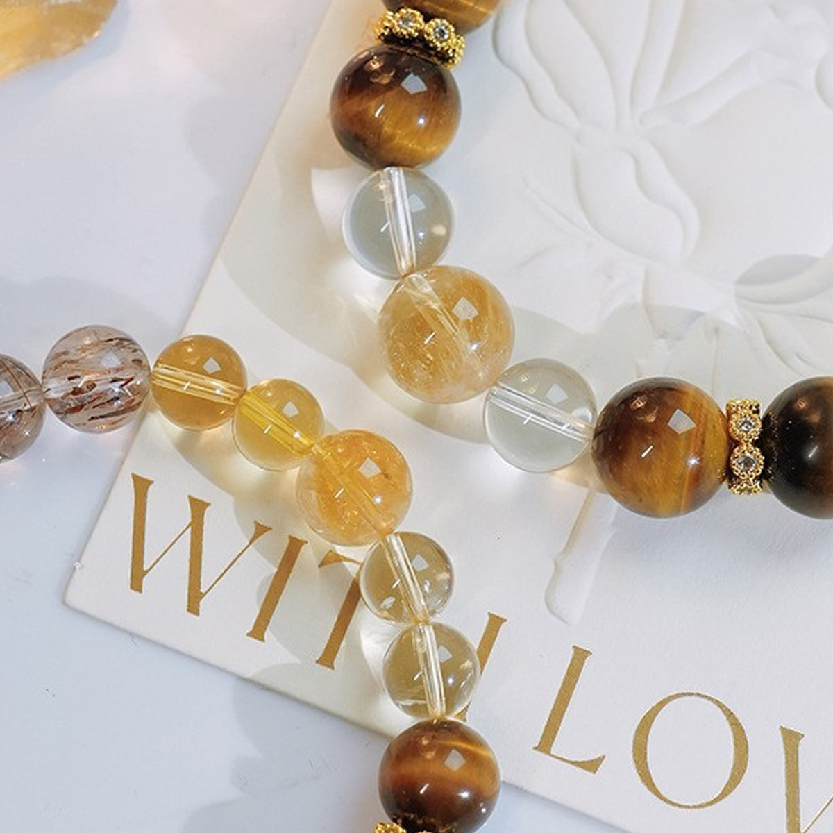 An aerial view of four types of crystals alternately arranged, showcasing their unique energy combination and synergistic protective effect