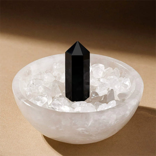 The crystal bowl used as a chic desktop decor next to a laptop and journal for positive energy at work.