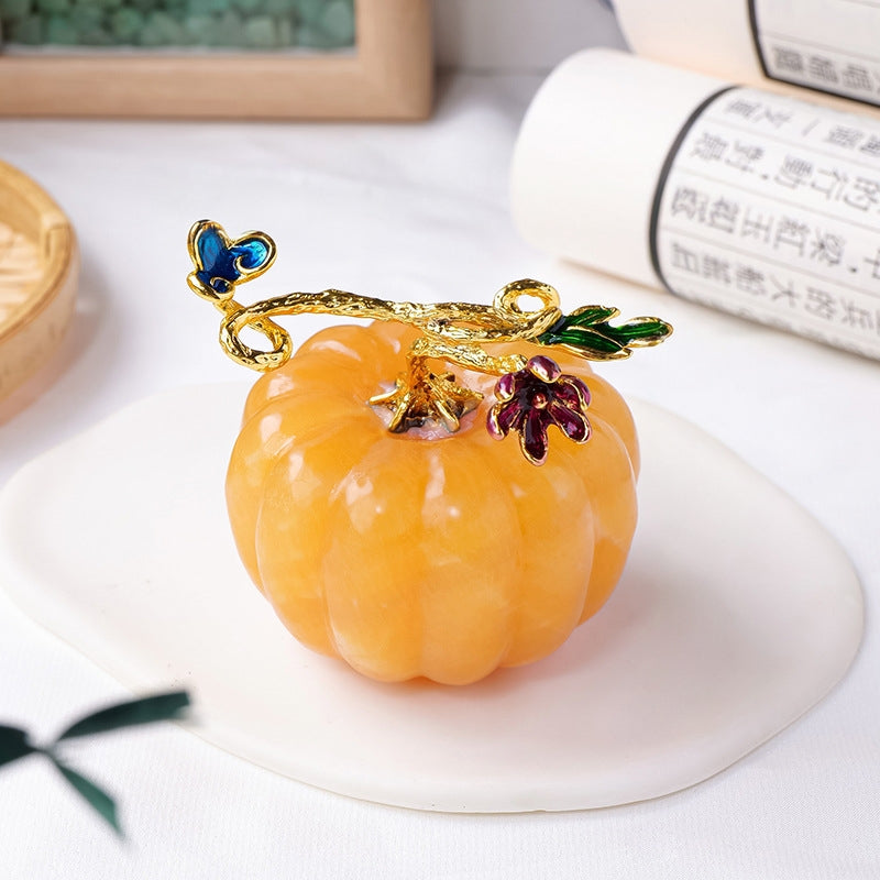 The golden frozen stone pumpkin sparkles with a warm golden glow in natural light, showcasing its high-frequency vibration as an energy amplifier.