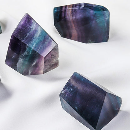 A close-up of the green fluorite square cone geometry, showcasing its precise cutting technique and the natural cloud-like texture inside, symbolizing the stable and accepting energy of the earth element.