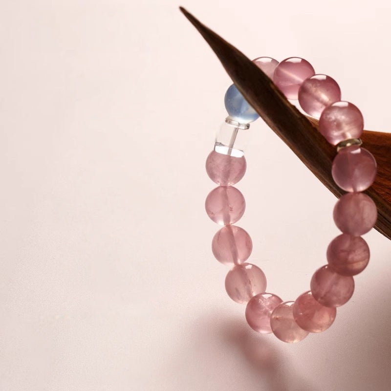 A close-up of rose quartz and aquamarine alternating, symbolizing the opening of the heart chakra and emotional healing