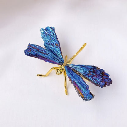 The sculpture is placed on the entrance cabinet, and the morning light filters through the blue feathers, casting dreamy shadows on the wall