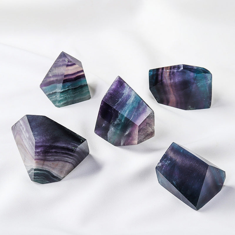 Under side light, the seven-color fluorite geometric body presents a semi-transparent texture and soft luster, demonstrating its energy characteristics as a container of light.