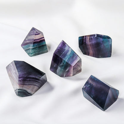 Under side light, the seven-color fluorite geometric body presents a semi-transparent texture and soft luster, demonstrating its energy characteristics as a container of light.