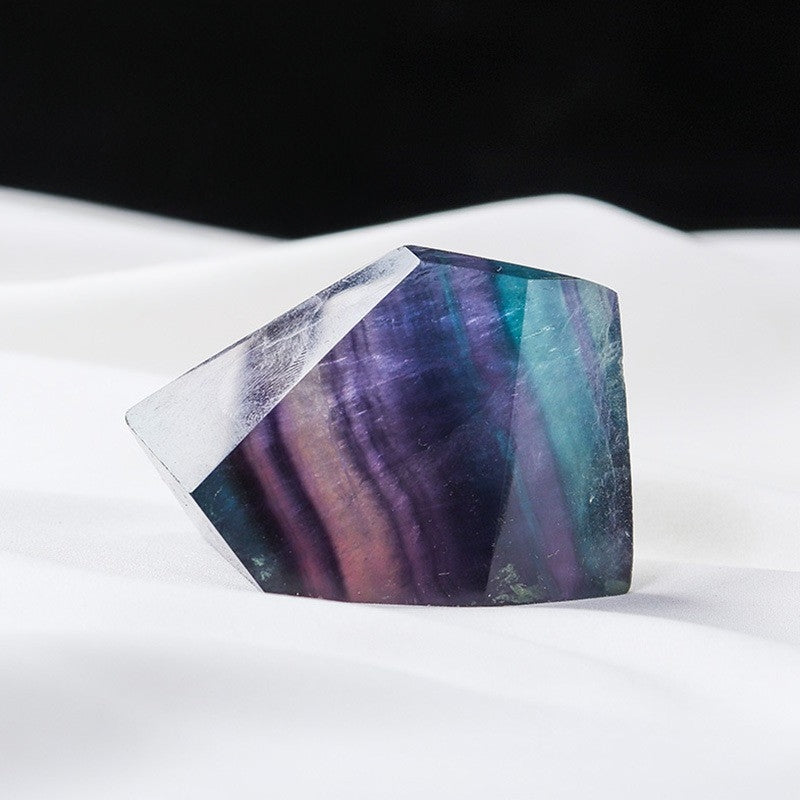 The seven-colored fluorite geometric shapes surround the meditation cushion, creating a sacred and protected meditation space for the seven chakras healing practice.