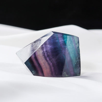 The seven-colored fluorite geometric shapes surround the meditation cushion, creating a sacred and protected meditation space for the seven chakras healing practice.