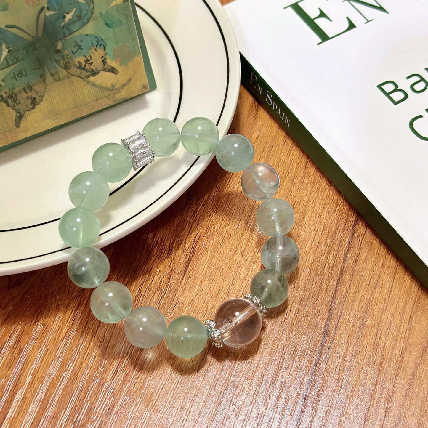 The green fluorite and white crystal two-color bracelet is laid flat, presenting a perfect combination of mint green and ice-clear texture