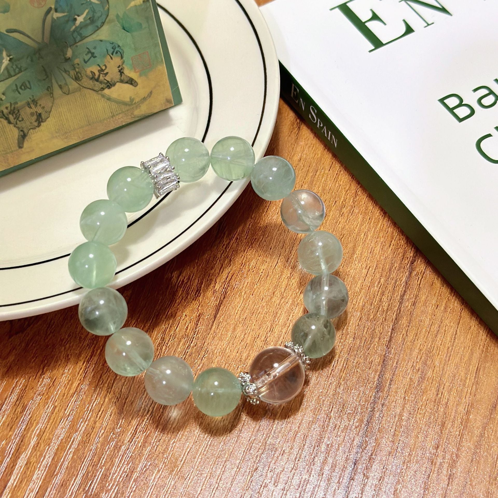 The green fluorite and white crystal two-color bracelet is laid flat, presenting a perfect combination of mint green and ice-clear texture