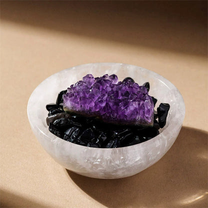 The Aura Sanctuary bowl as a centerpiece on a modern living room coffee table with books and a plant.