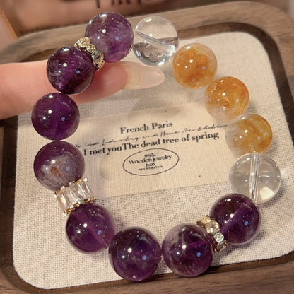 A close-up of a girl wearing an amethyst bracelet on her wrist highlights the natural crystal's sleep-aiding, stress-relieving effects and daily meditation functions