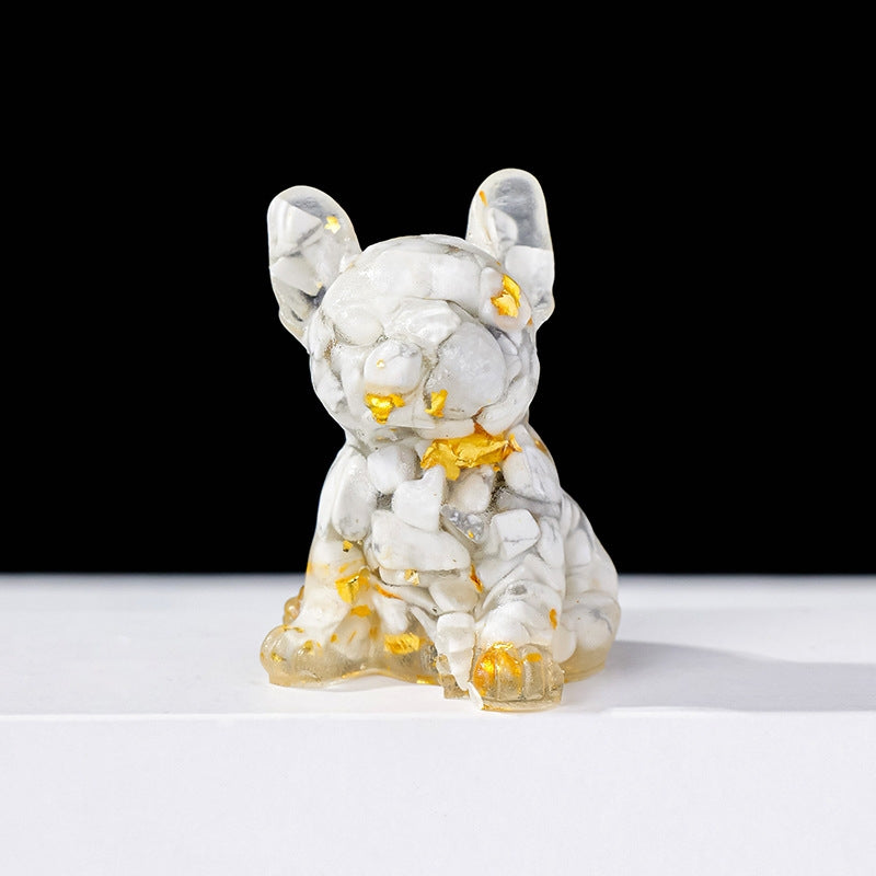 The warm glow of the crystal puppy under the desk lamp at night