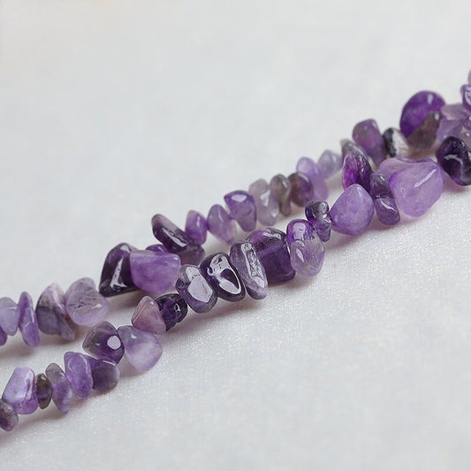 White crystal raw stone fragments with holes, materials for DIY purification bracelets and home decoration.