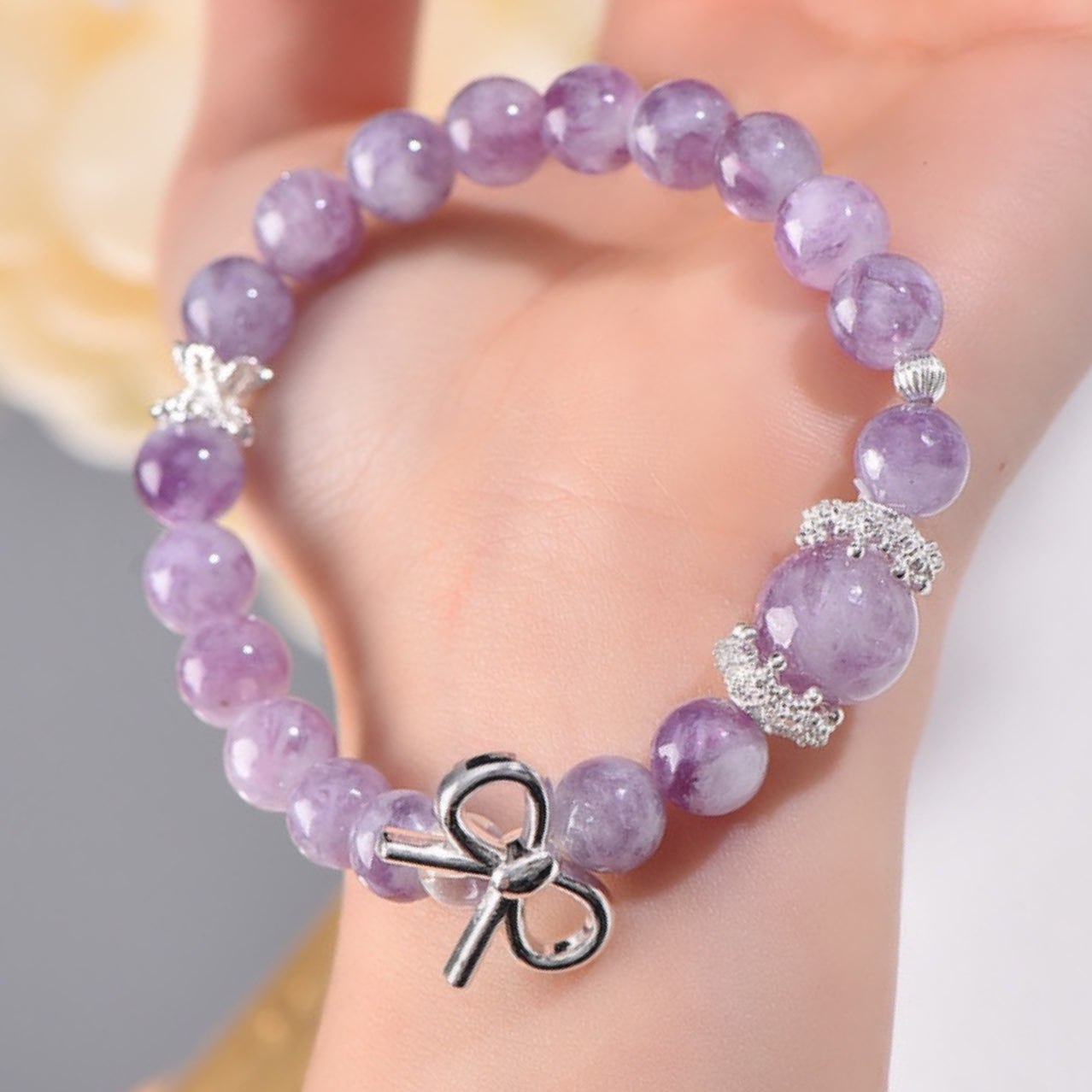 A detailed close-up of the pure silver butterfly accessory showcases the texture of the wings and the symbolic meaning of transformation and rebirth