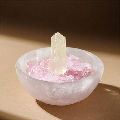 In an energy healing setting, the Selenite bowl is shown alongside other healing crystals like amethyst and malachite as a core tool for space cleansing.