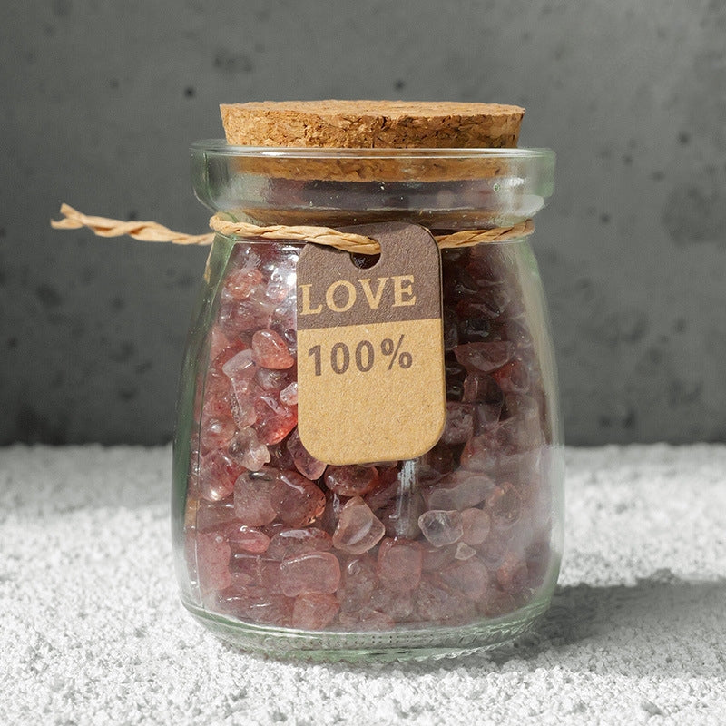 Crystal bottles are placed in the creative workspace, surrounded by scattered design sketches, inspiring creativity.