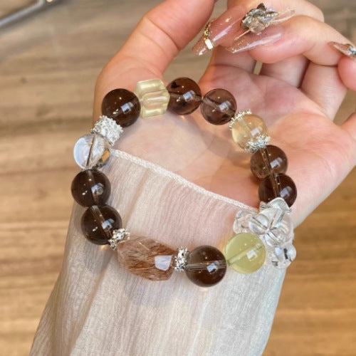A panoramic view of the black gold Super Seven, Sunstone and yellow crystal three-color energy bracelet, showcasing a powerful energy matrix and high-end texture