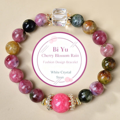 A close-up of tourmaline and cherry blossom accessories showcases the romantic atmosphere and energy field of the cherry blossom rain in spring