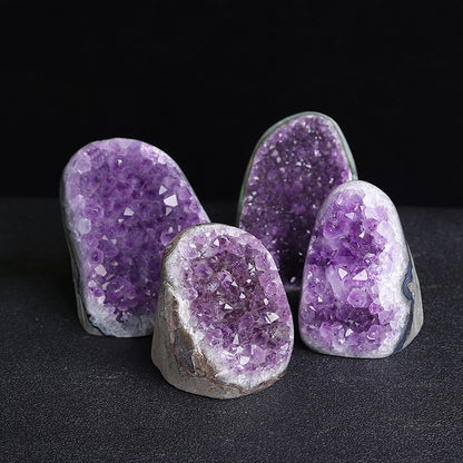 A beam of light penetrates the Uruguayan amethyst cluster, revealing its deep internal color and transparent crystal structure, like an activated energy channel.
