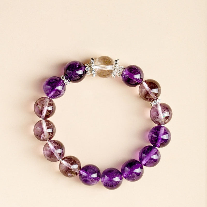 A close-up of a dark Uruguayan amethyst bracelet, showcasing its rich purple color and transparent crystal texture