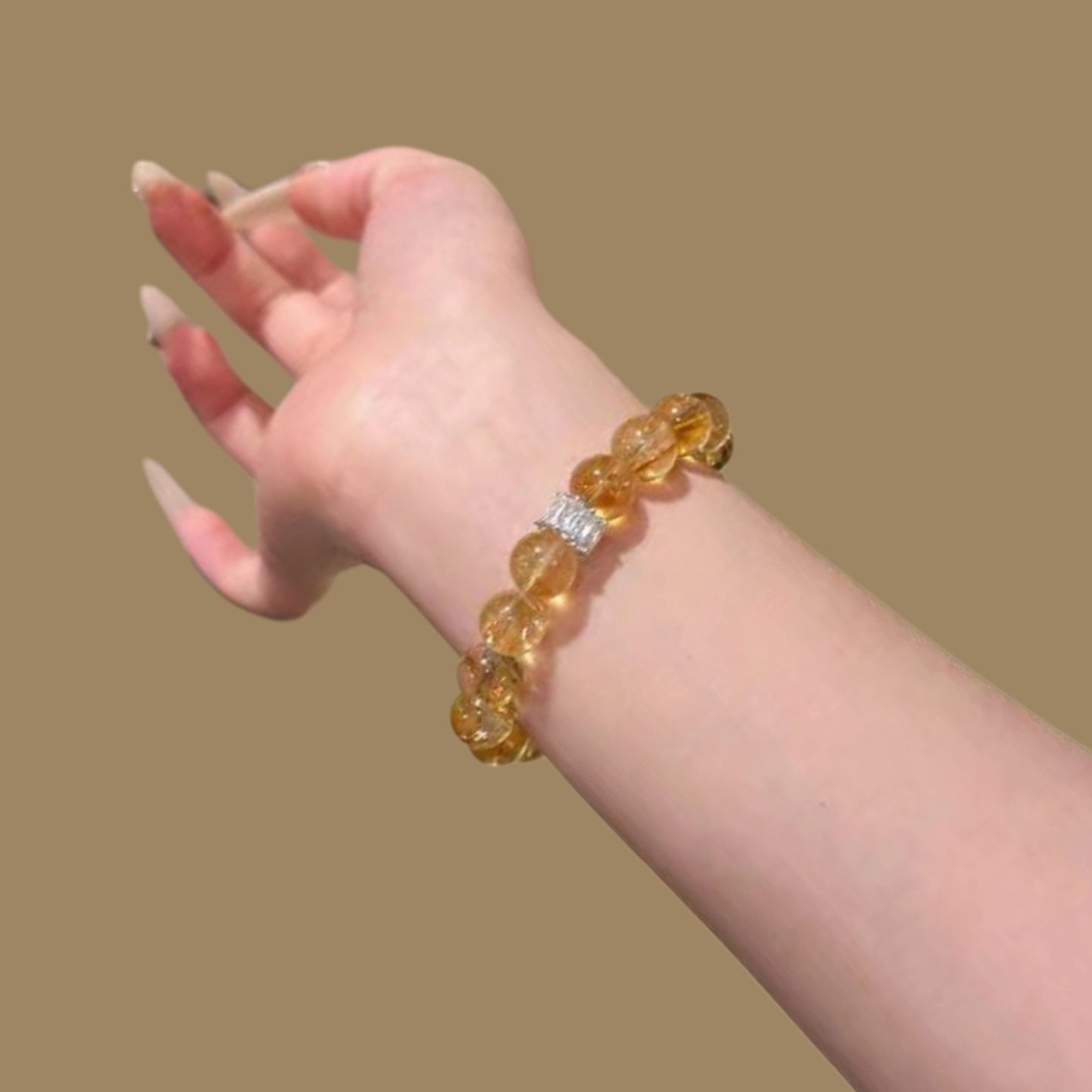 The golden crystal bracelet sparkles in natural light, symbolizing its powerful wealth attraction and abundant manifestation energy