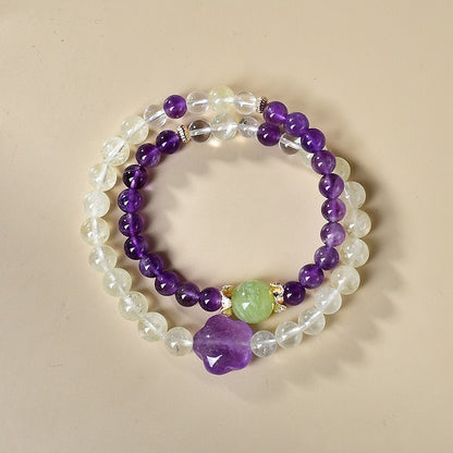 The bracelet is displayed flat, highlighting its dual energy effects of attracting wealth and enhancing wisdom