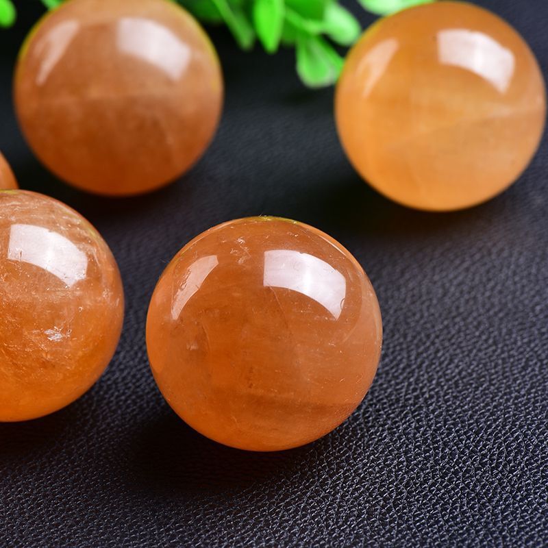 Yellow calcite sphere glowing in sunlight