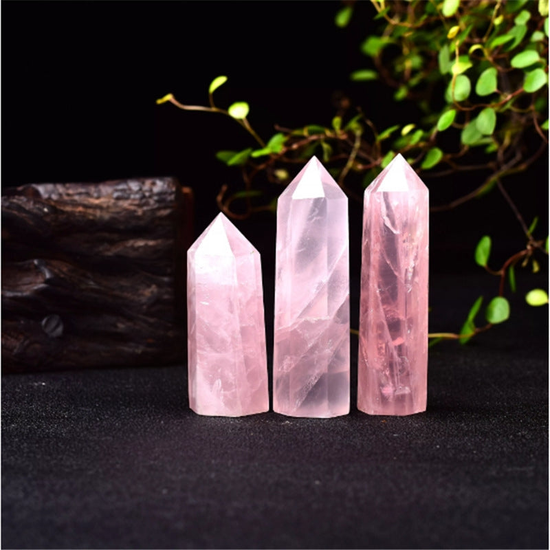 Holding a Rose Quartz crystal point in hand during meditation and energy healing practice.