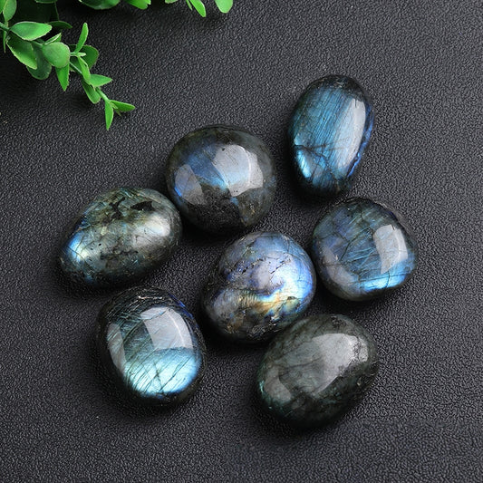 Front view of natural labradorite palm stone showing blue flash