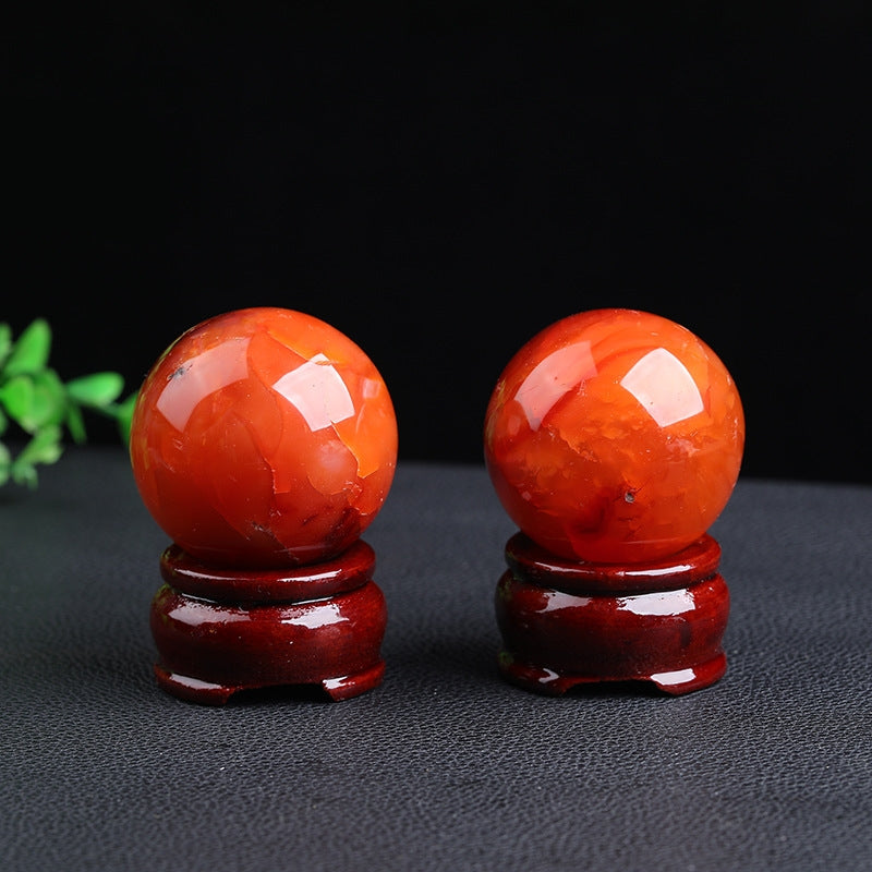 Main product shot of natural red agate ball showing red veins and perfect sphere